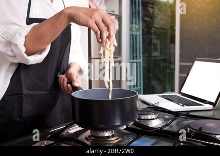 Chef Cutting cook Homemade makes dough fresh Pasta Stock Photo