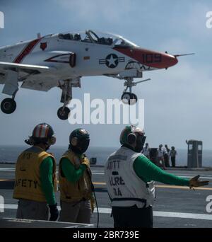 Sailors assigned to USS Gerald R. Ford's (CVN 78) air department observe a T-45C Goshawk, attached to Training Air Wing 1, as it prepares to land during flight operations May 17, 2020. Ford is underway in the Atlantic Ocean conducting carrier qualifications. (U.S. Navy photo by Mass Communication Specialist 2nd Class Ruben Reed) Stock Photo