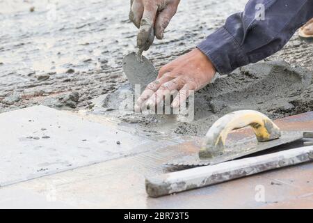 Mason was repaired for the floor tiles Stock Photo