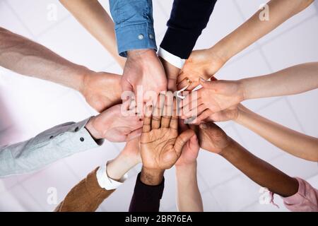 Multi-ethnic Group Of People Stacking Hand Showing Unity Stock Photo