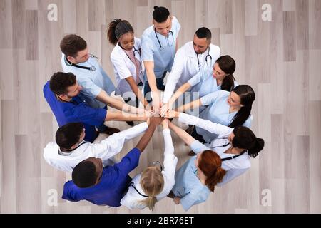 Directly Above Shot Of Medical Team Stacking Hands Together At Hospital Stock Photo