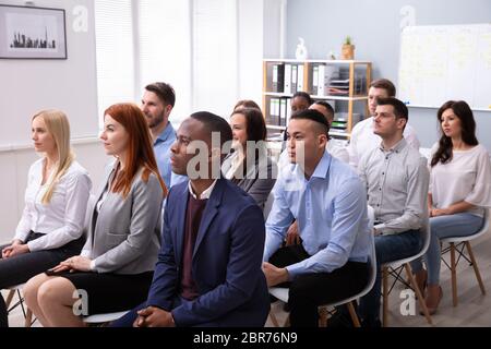 Diverse Group Of Successful Business People Sitting On Chair In The Conference Room Stock Photo