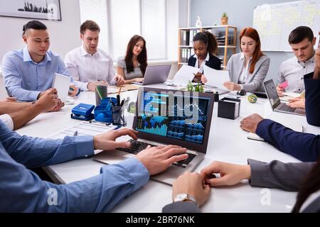 Close-up Of A Businessman Analyzing The Graph On Laptop In The Meeting Stock Photo