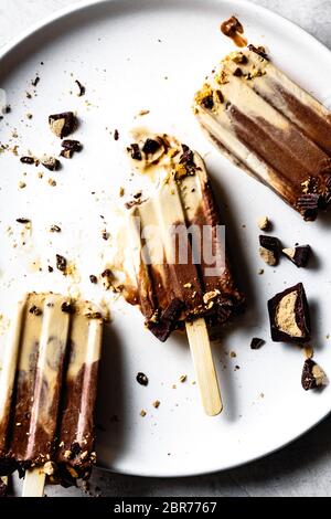 Homemade peanut butter and chocolate fudge popsicles. Stock Photo