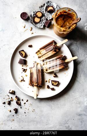 Peanut butter and chocolate fudge popsicles with ingredients. Stock Photo