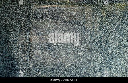 Broken glass background with pattern with the city in the background. Destruction, security, armored, shard, vandalism. Stock Photo
