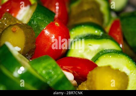Vegetable salad sliced tomatoes, cucumbers, onions and pickles. Close up. Healthy food, fitness diet Stock Photo