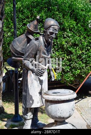 Copper sculpture of a water carrier in Karaalioglu Park. Stock Photo