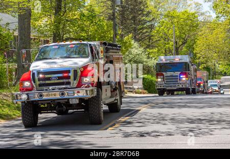 several Shelter Island fire trucks with lights on Stock Photo