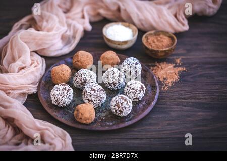 Homemade chocolate almond truffles served on a ceramic plate Stock Photo