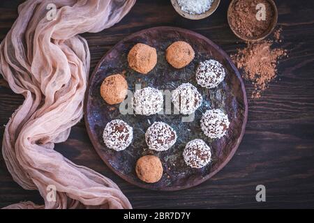 Homemade chocolate almond truffles served on a ceramic plate Stock Photo