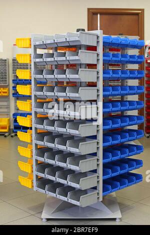 Big Storage Organizer Tower Shelf With Plastic Sorting Bins Stock Photo