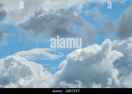 White and thunderclouds in the blue sky. Close up. Stock Photo