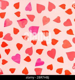 collage of many hearts cut from pink and red papers on pink pastel paper Stock Photo