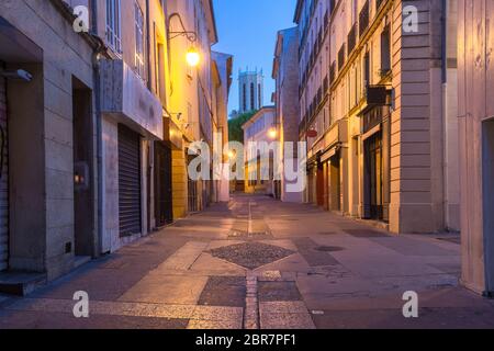 Empty street and Aix Cathedral or Cathedral of the Holy Saviour of Aix-en-Provence at night, Provence, southern France Stock Photo