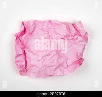 crumpled pink rectangular sheet of paper on a white background, copy space Stock Photo