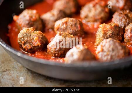 close up of rustic italian meatballs in tomato sauce Stock Photo