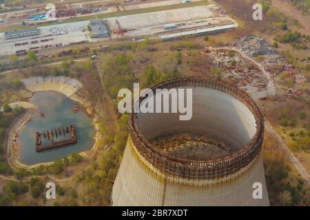 Drone flies over cooling tower near Chernobyl nuclear power plant. Chernobyl nuclear power plant. Cooling tower overlooking the nuclear power plant in Stock Photo
