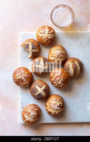 Soft pretzel buns and a glass of beer on the table Stock Photo