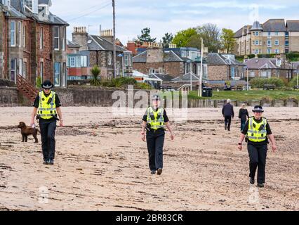 Policewomen patrol the beach during Covid-19 Coronavirus pandemic lockdown, North Berwick, East Lothian, Scotland, UK Stock Photo