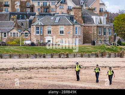 Policewomen patrol the beach during Covid-19 Coronavirus pandemic lockdown, North Berwick, East Lothian, Scotland, UK Stock Photo