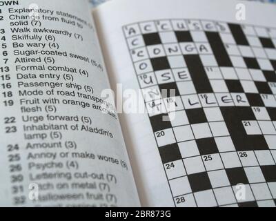 Awkwardly crossword clue
