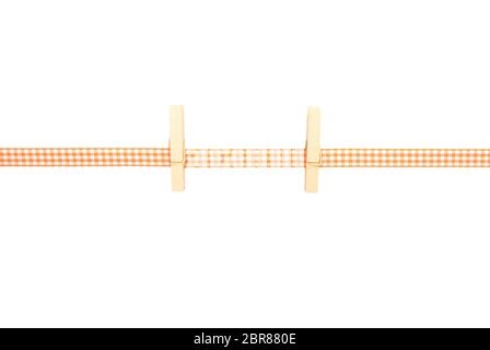 Background with orange-white checkered ribbon and pegs Stock Photo