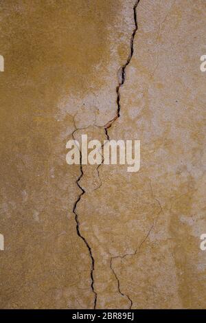 The structure of the old wall with a distinct crack Stock Photo