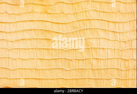 Yellow stylized imitation crocodile skin background Stock Photo