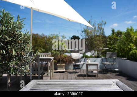 Sun terrace with empty wooden table for recreation Stock Photo