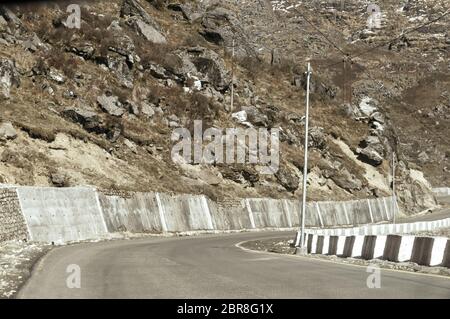 Highway road view of India China border near Nathu La mountain pass in Himalayas which connects Indian state Sikkim with China's Tibet Region, trisect