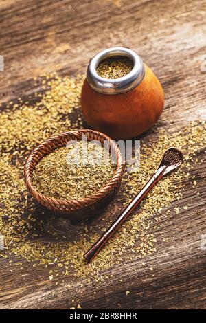 Pile of mate tea leaves and mate tea drink served in calabash gourd Stock Photo
