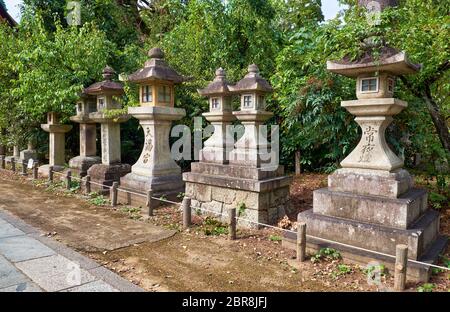 The view of the kaku-doro traditional stone square lanterns along the footpath at the Kitano Tenmangu shrine. Kyoto. Japan Stock Photo