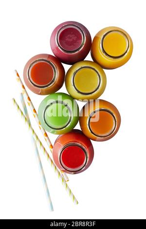 Several isolated glass jars without caps filled with different colors of blended juices on white surface Stock Photo