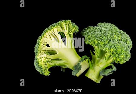 Broccoli florets cut in half on a black background Stock Photo
