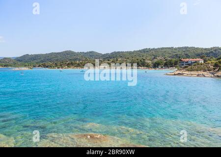 View of Lagonisi famous beach with clear sea water at the coast of Sithonia Halkidiki Greece Stock Photo