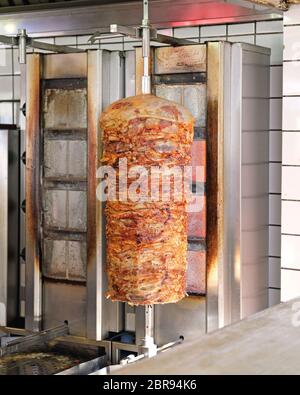 Rotisserie with Greek Pork Meat Gyros Kebab Stock Photo