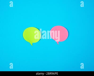 two color paper stickers on a blue background, close up Stock Photo