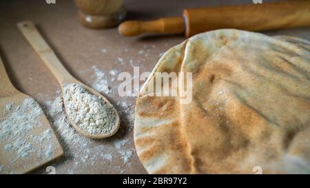 Kuboos or khubz - Arabic bread on a brown table in the kitchen Stock Photo
