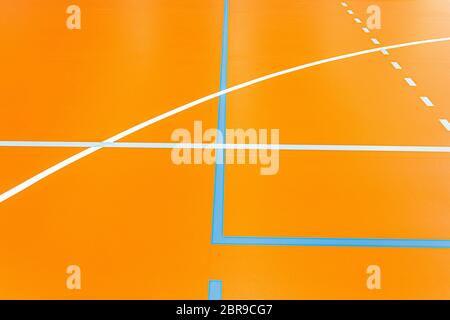 Colorful lines on the floor of a sports arena, orange blue white Stock Photo