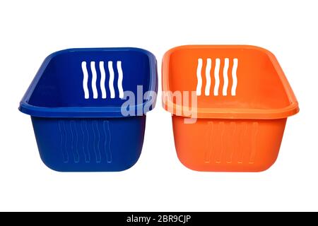 Empty basket isolated. A empty orange and a blue plastic laundry basket isolated on a white background. Household objects. Stock Photo