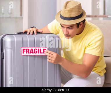 The man going on vacation with fragile suitcases Stock Photo