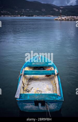 Small blue wooden rowing fisherman boat in the port and harbour in the Alykes Bay in Zante, Greece