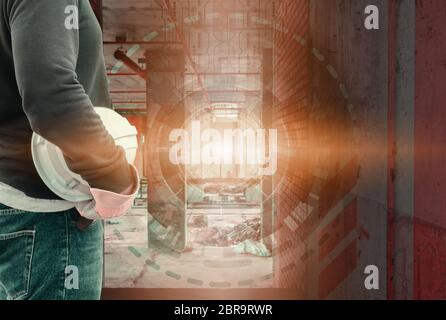 Double exposure of engineering hand holding white safety hat in building and digital circuit line technology interior working construction site backgr Stock Photo