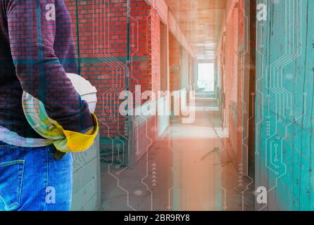 Double exposure of engineering hand holding white safety hat in building and digital circuit line technology interior working construction site backgr Stock Photo