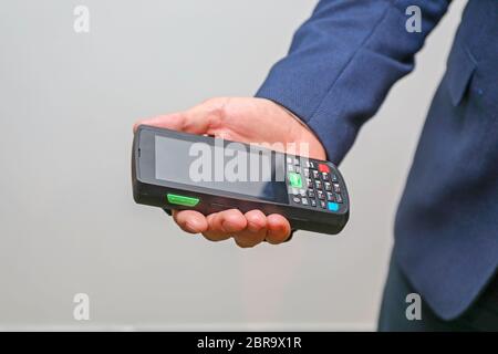 Man Holding Handheld Barcode Scanner Reader Portable Computer Stock Photo