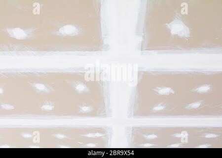 gypsum board ceiling structure and plaster mortar wall painted foundation white decorate interior room in building construction site Stock Photo