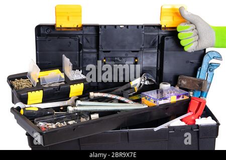Plumber or carpenter tool box isolated. Black plastic tool kit box with assorted tools and with various nails, screws, fasteners as well as dowels iso Stock Photo