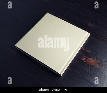 Photo of blank hardcover book on dark wooden background. Stock Photo
