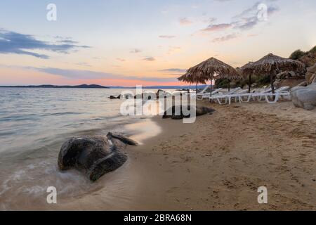 sunset on the beach near Ouranoupolis city. Halkidiki, Greece Stock Photo